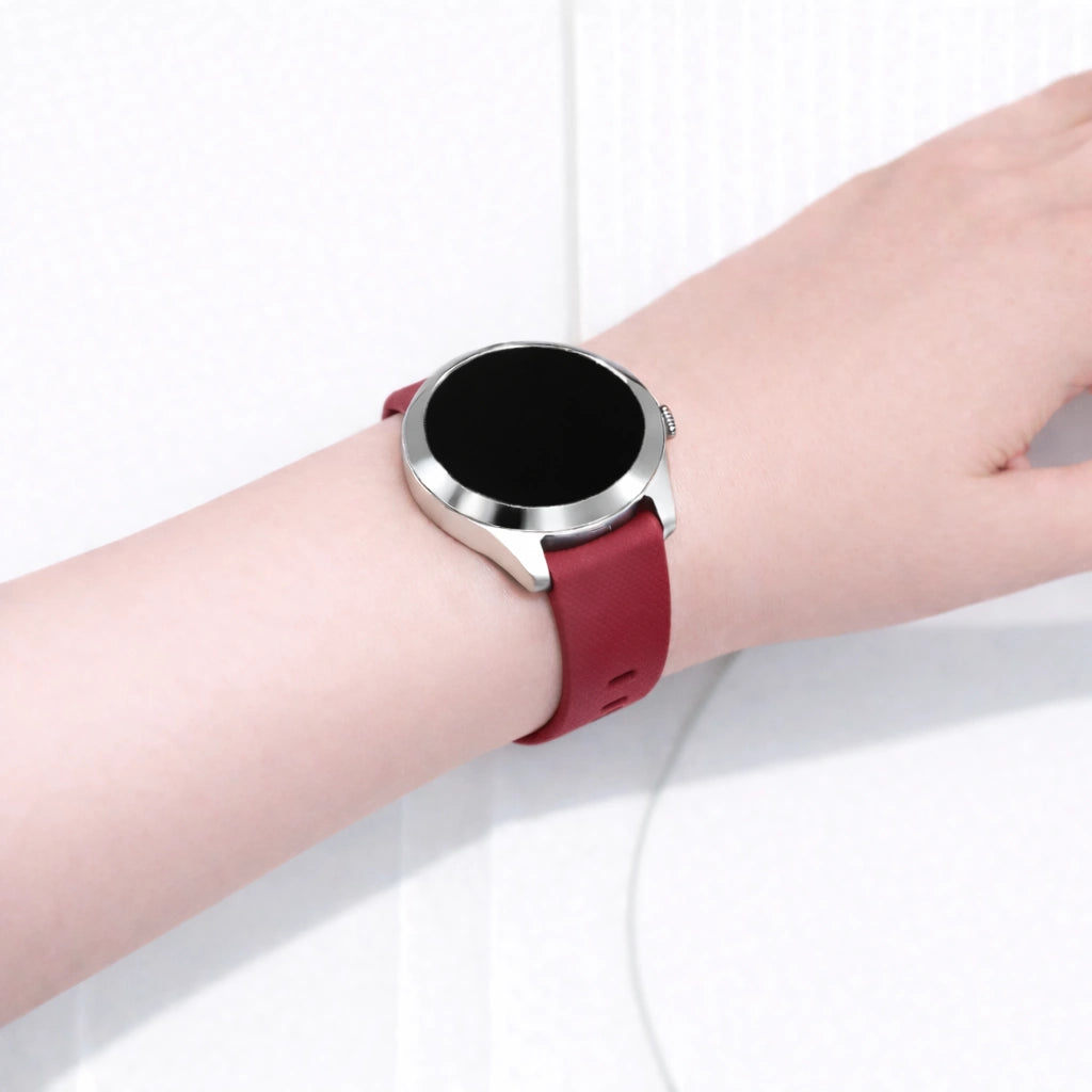 Garmin Vivoactive 4S smartwatch worn on the wrist with a red silicone watch strap and silver case