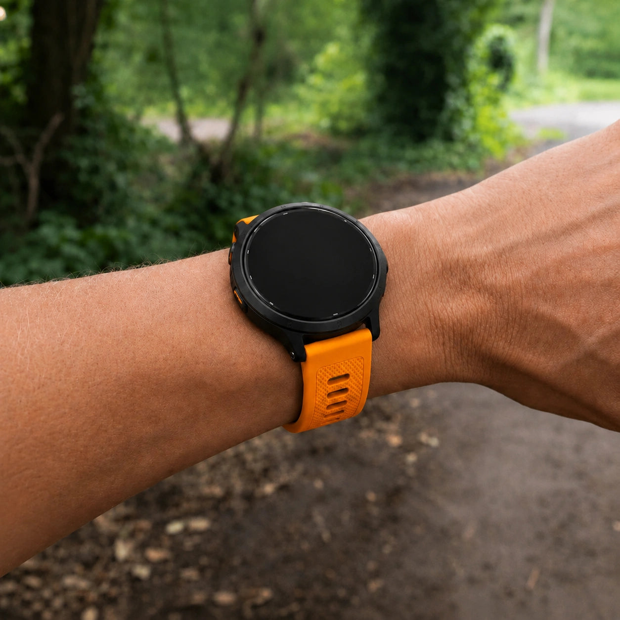 User wearing an orange Garmin Vivoactive 5 watch band during an outdoor walk
