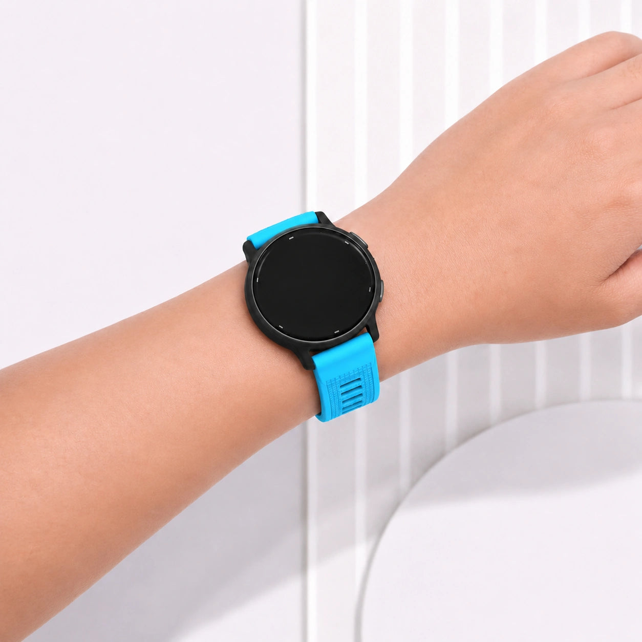 Light blue silicone strap for Garmin Vivoactive 6 worn on wrist indoors