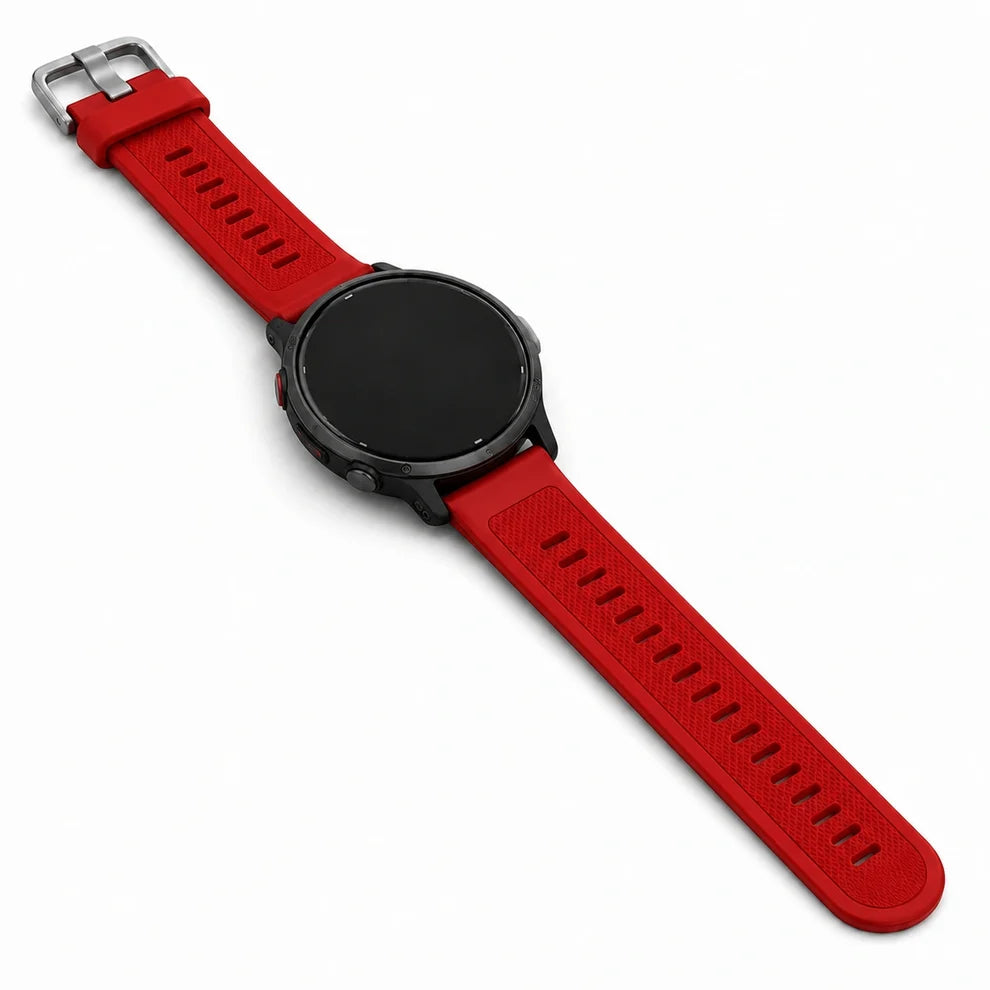 Red Garmin Vivoactive wristband fitted to a black round watch, shown laid flat