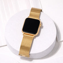 Gold Apple Watch metal band with milanese mesh displayed on a white stand