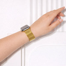 Gold metal Apple Watch strap worn on the wrist with a breathable mesh design