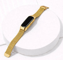 Gold Milanese watch strap for Fitbit Inspire 3 on a display stand