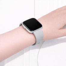 Grey silicone strap worn on wrist, designed for Fitbit Versa 2 with a smooth, comfortable fit
