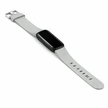 Grey silicone wristband compatible with Fitbit Luxe displayed on white background