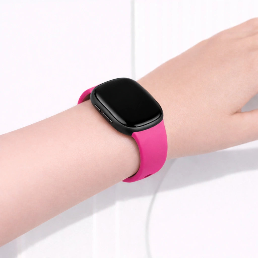 Hot pink replacement strap for Fitbit Versa 3 fitted securely on the wrist