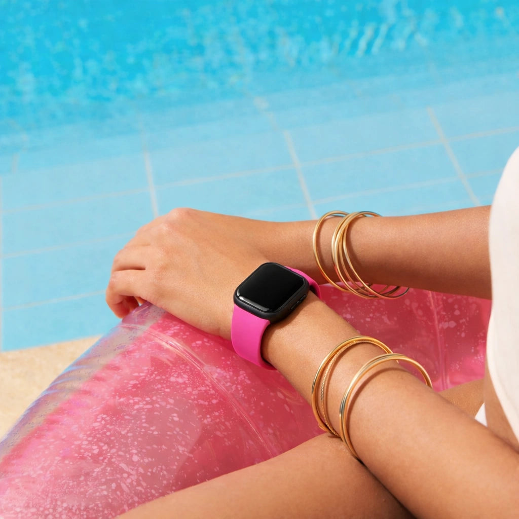 Hot pink band for Fitbit Versa 4 worn poolside with a bright, summer look