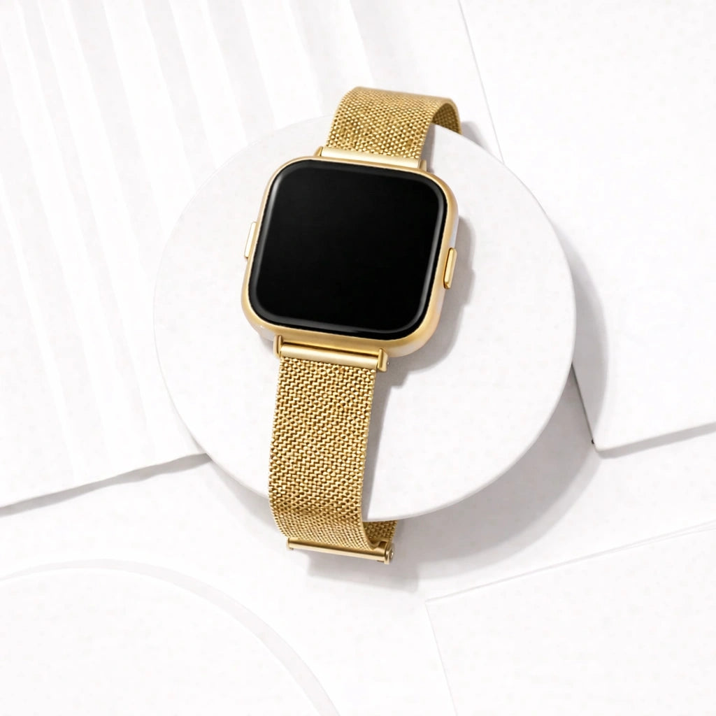 Gold stainless steel mesh watch strap for Fitbit Versa 2 displayed in a clean flat lay setting