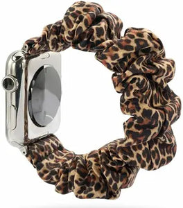 Leopard print scrunchie-style Apple Watch strap with soft elastic fabric in brown and black tones
