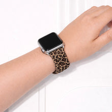 Leopard print scrunchie Apple Watch strap worn on wrist with soft elastic fabric design