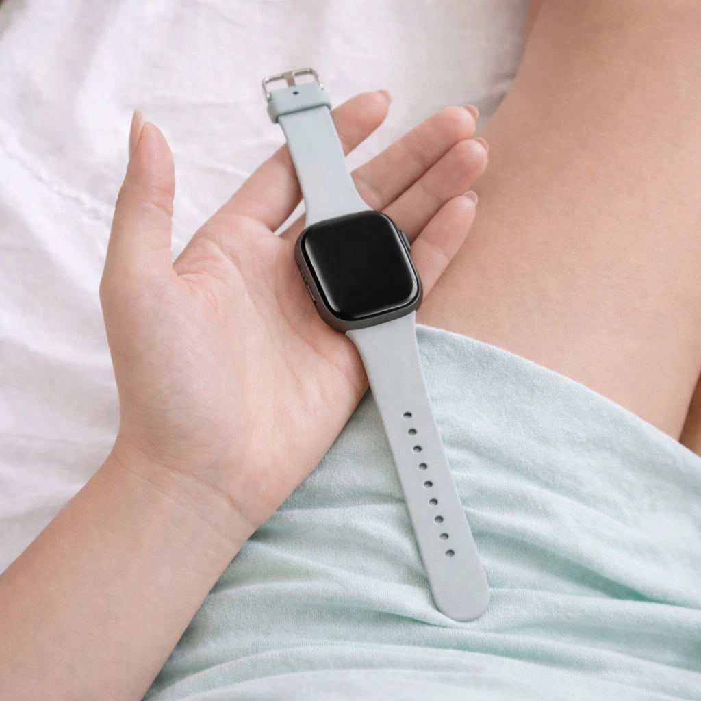 Light grey replacement band for Fitbit Versa 4 shown in a relaxed, everyday lifestyle setting