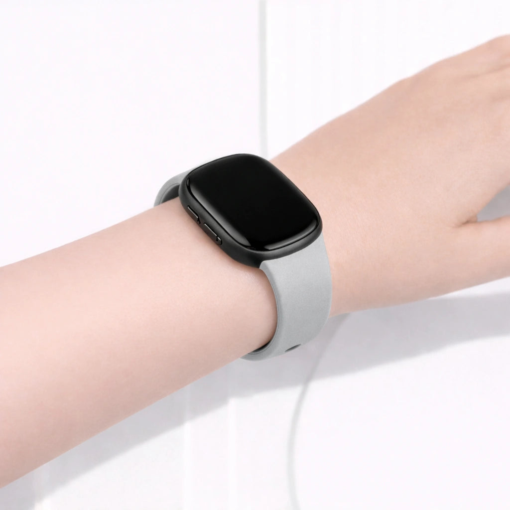 Light grey Fitbit Versa 3 band worn on the wrist for everyday comfort
