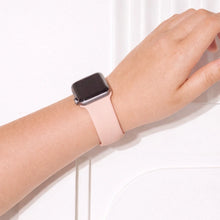 Light pink Apple Watch wristband worn on wrist with soft flexible silicone fit