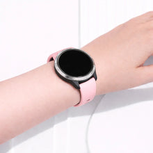Garmin Venu fitness watch worn with a light pink silicone band
