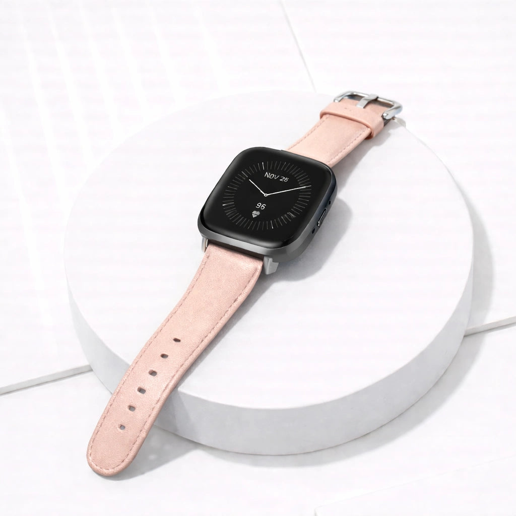 Light pink leather wristband for Fitbit Versa 3 displayed flat with stainless steel buckle.