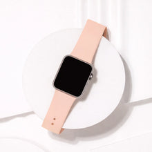 Light pink silicone watch band for Apple Watch displayed on minimal white background