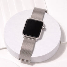 Silver metal Apple Watch strap displayed in a clean flat lay on a white circular stand