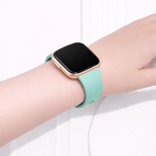 Mint Fitbit Versa 2 strap worn on the wrist with smooth silicone finish