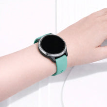 Garmin Venu smartwatch worn with a mint silicone sport band