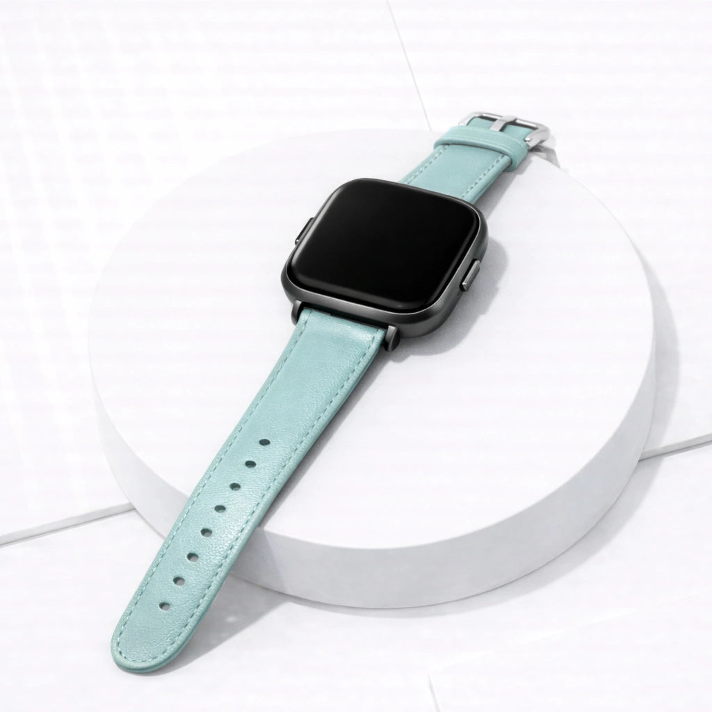 Mint leather strap for Fitbit Versa 2 displayed flat, showing premium leather finish and stainless steel buckle