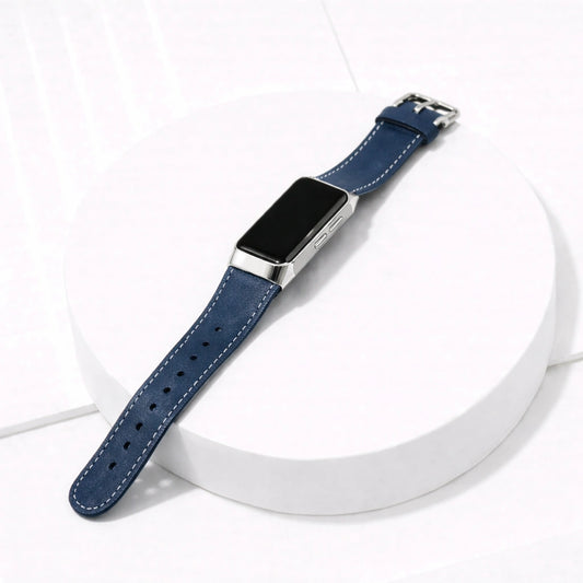 Fitbit Charge 5 navy leather watch strap with silver buckle shown on white platform