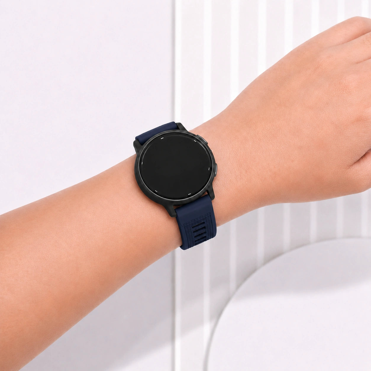 Navy silicone watch band for Garmin Vivoactive 6 worn on wrist indoors