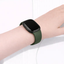 Fitbit Versa 3 strap in green silicone worn on the wrist with a secure, comfortable fit