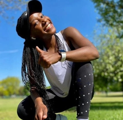 Smiling runner giving a thumbs up during an outdoor workout, wearing a fitness smartwatch with a comfortable sports strap, perfect for active lifestyles.