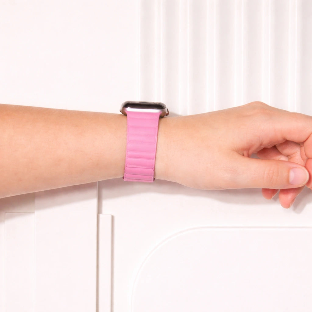 Pink leather Apple Watch band worn on the wrist.
