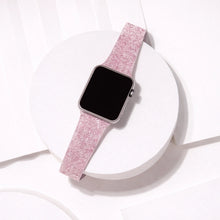 Pink sparkly Apple Watch band displayed in a clean flat lay showing shimmer finish