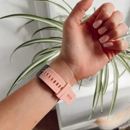 Wearing a stylish smartwatch strap at home with a soft pink finish