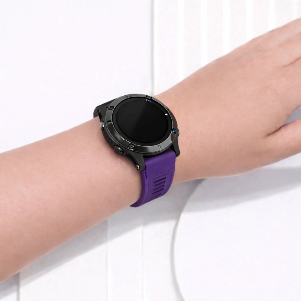 Close-up of purple Garmin Forerunner 955 strap on wrist showing adjustable fit