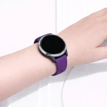 Garmin Venu smartwatch worn with a purple silicone sport band