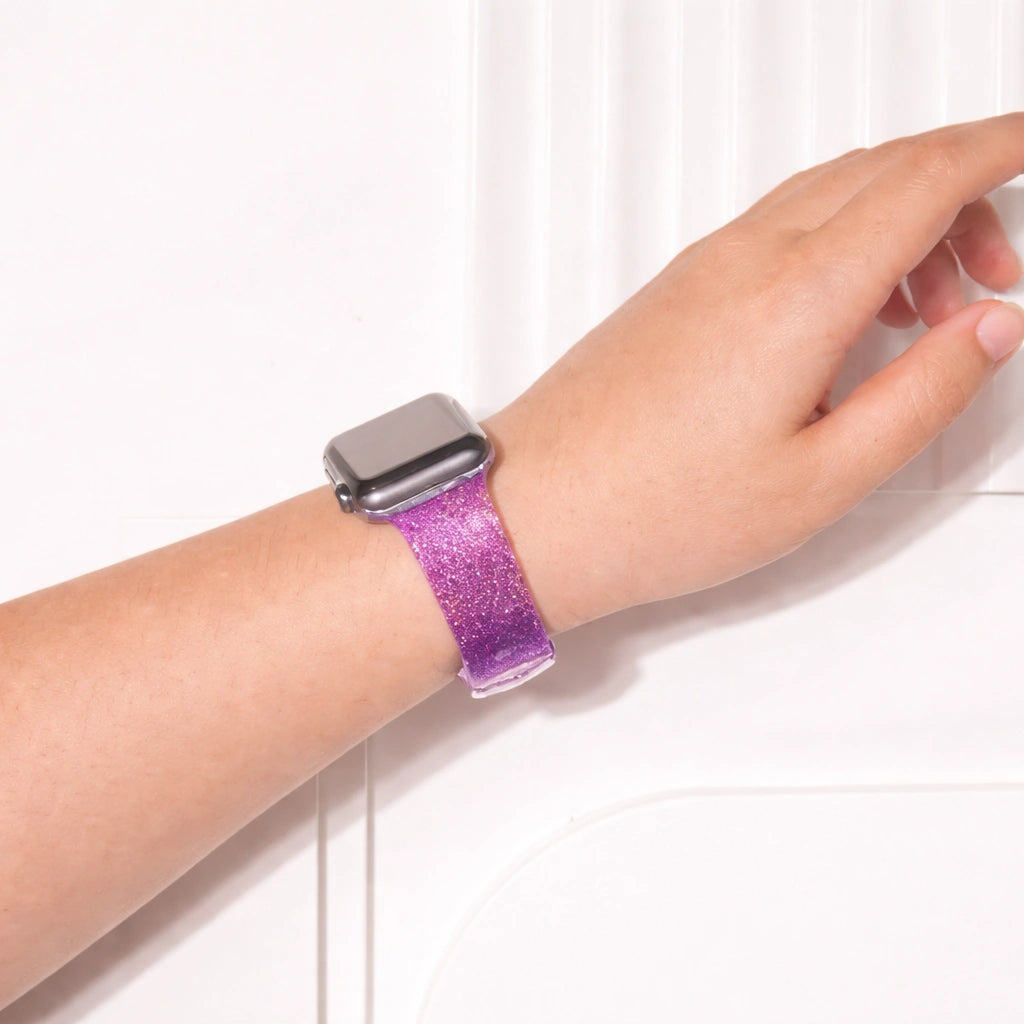 Purple glittery Apple Watch wristband worn on wrist with soft gradient shimmer