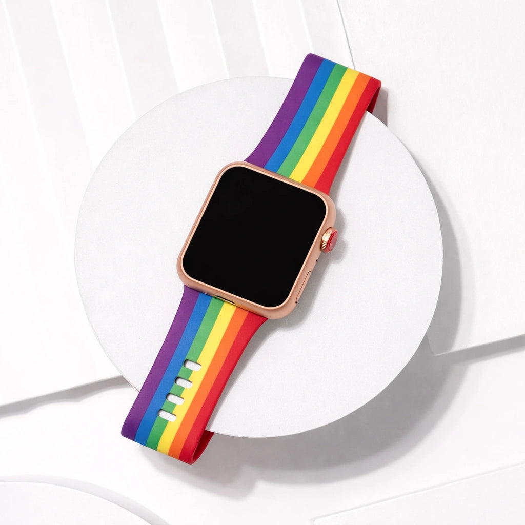 Rainbow pattern Apple Watch strap displayed on a white platform background.
