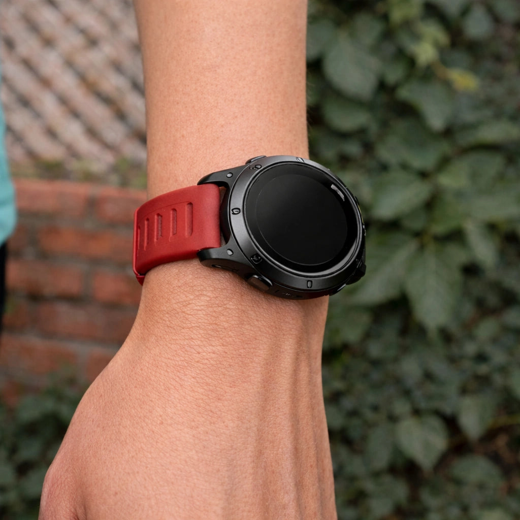 Garmin Forerunner 955 red strap worn on wrist with secure and flexible silicone design