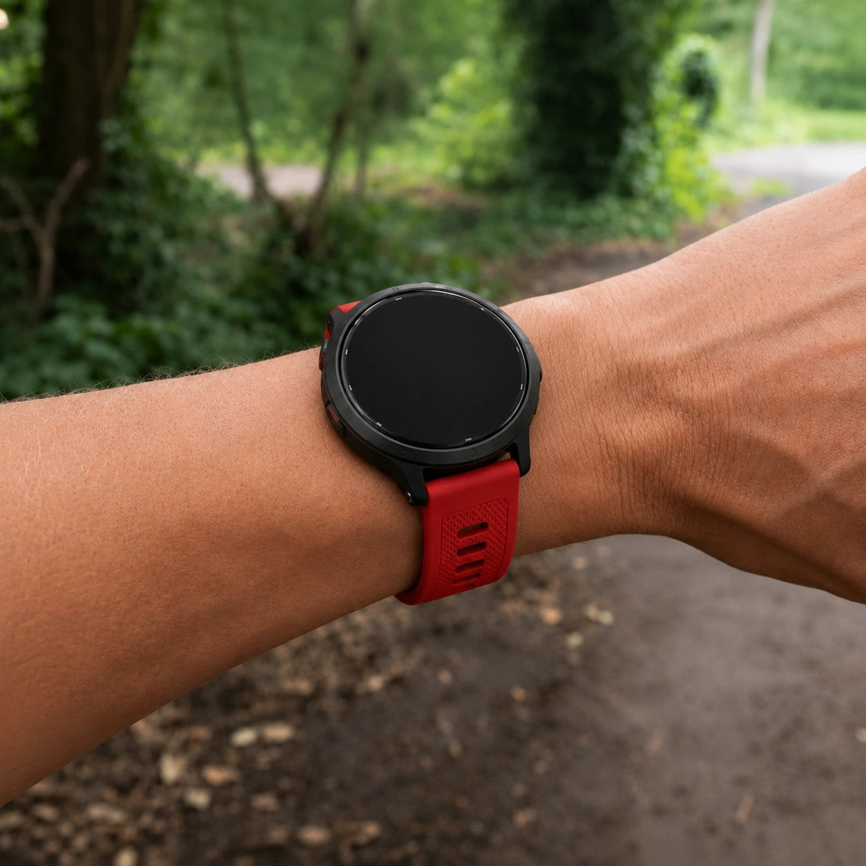 Red Garmin Venu 3S strap worn during an outdoor walk.