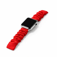 Red scrunchie Apple Watch strap worn on wrist with soft elastic fabric design