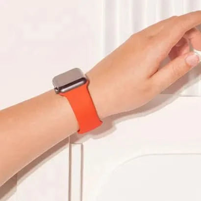 Red silicone Apple Watch SE strap shown on wrist, perfect for sporty everyday style.