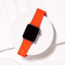 Red silicone band for Apple Watch displayed on minimal white background