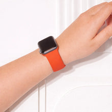 Red silicone watch strap for Apple Watch worn on wrist with flexible comfortable fit