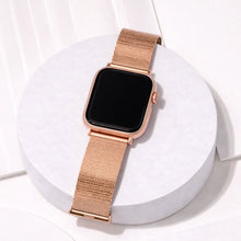 Rose gold metal band for Apple Watch displayed on a minimal studio stand