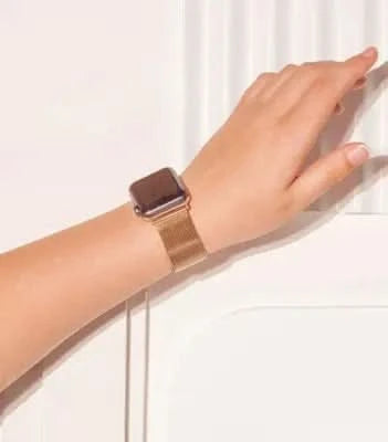 Rose gold metal strap for Apple Watch SE worn on wrist, elegant and lightweight.