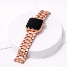 Rose gold stainless steel Apple Watch band in metal link style worn on wrist