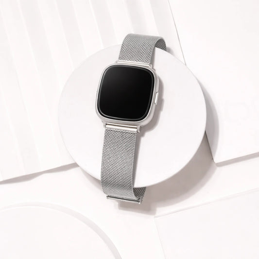 Silver Milanese mesh strap for Fitbit Versa 3 displayed on a clean flat lay background