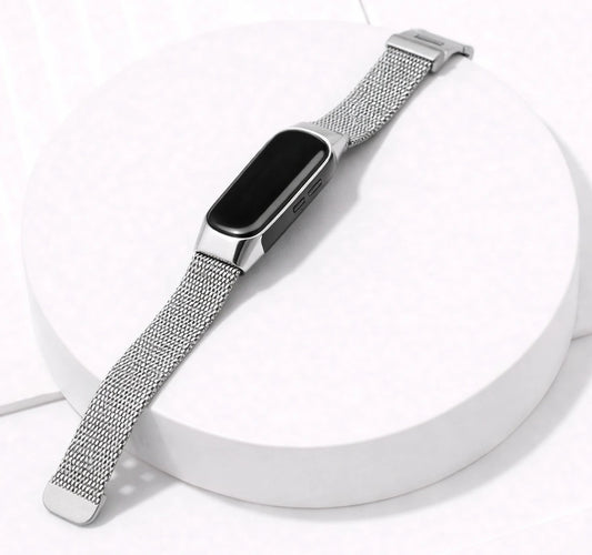 Silver Milanese watch band for Fitbit Inspire 3 displayed on a stand