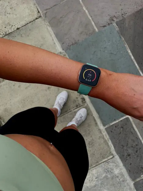 Fitness smartwatch with a green strap after a workout