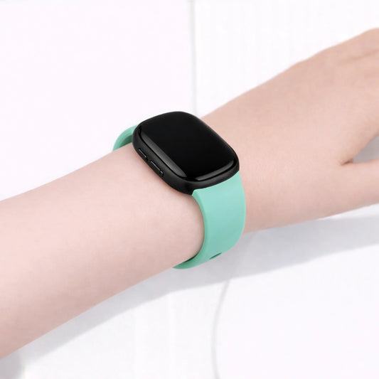 Teal band worn on the wrist, designed for Fitbit Versa 4