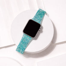 Teal sparkly Apple Watch strap displayed in a clean flat lay with shimmering texture