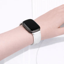 White leather Fitbit Versa 3 watch strap worn on the wrist, showing a comfortable and adjustable fit.